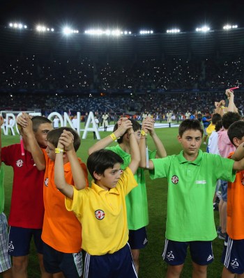 TBILISI, GEORGIA - AUGUST 11:  Children lift the arms during the pre-match entertainment during the UEFA Super Cup between Barcelona and Sevilla FC at Dinamo Arena on August 11, 2015 in Tbilisi, Georgia.  (Photo by Chris Brunskill/Getty Images)