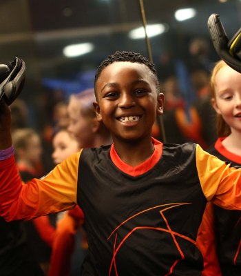 MANCHESTER, ENGLAND - APRIL 17: A young MasterCard mascot poses with gloves received from Ederson of Manchester City during the UEFA Champions League Quarter Final second leg match between Manchester City and Tottenham Hotspur at Etihad Stadium on April 17, 2019 in Manchester, England. (Photo by Jan Kruger - UEFA/UEFA via Getty Images)