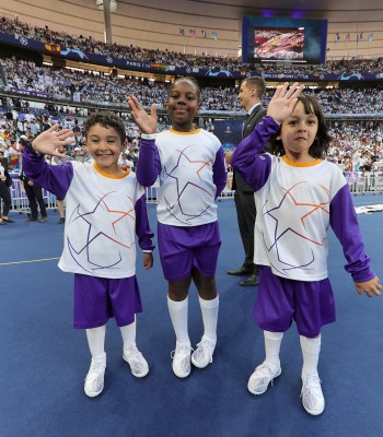 PARIS, FRANCE - MAY 28: FedEx & Mastercard Referee and Player Escort Kids watching the warm-up during the UEFA Champions League final match between Liverpool FC and Real Madrid at Stade de France on May 28, 2022 in Paris, France. (Photo by Joosep Martinson - UEFA/UEFA via Getty Images)